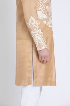 Gold straight kurta featuring ivory aari embroidery in floral and geometric pattern. Paired with contrasting plain pant. - Aza Fashions Fitted Raw Silk Sherwani With Embroidered Border, Wedding Chanderi Bandhgala With Embroidered Border, Wedding Bandhgala With Embroidered Border In Chanderi, Wedding Bandhgala With Embroidered Border, Raw Silk Sherwani With Embroidered Border And Straight Kurta, Raw Silk Sherwani With Embroidered Border, Sherwani With Embroidered Border In Raw Silk, Embroidered Border Sherwani In Raw Silk, Embroidered Silk Sherwani Straight Kurta