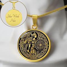 a gold necklace with an image of a woman holding a bird on it's back