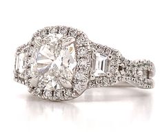 an oval and baguette cut diamond ring with two rows of diamonds surrounding it