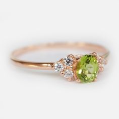 Engagement Ring Details 14k Solid Rose Gold (Also available in White and Yellow Gold, Please select at checkout) 1.3mm (Approximate Band Width) Natural Peridot (Center Stone) Oval 4X3mm (Center Stone Dimensions) 0.16 Carats (Average Center Stone Weight) Surrounding Diamond Details White Diamonds 0.15 Carats (Total Diamond Weight/ 6 Pcs.) SI-H (White Diamond) Brilliant Cut Ring can be resized from 3-10, Metal can be made in 14, 18K/ White, Yellow and Rose Gold. For custom order this ring with a d Elegant Peridot Birthstone Ring With Prong Setting, Yellow Gold Peridot Diamond Ring With Birthstone, Peridot Diamond Ring With Round Cut, Peridot Birthstone Diamond Ring Fine Jewelry, Elegant Peridot Diamond Ring With Prong Setting, Peridot Round Cut Diamond Ring, Elegant Peridot Diamond Ring, Peridot Ring With Round Cut For May Birthstone, Round Cut Peridot Ring For May Birthstone