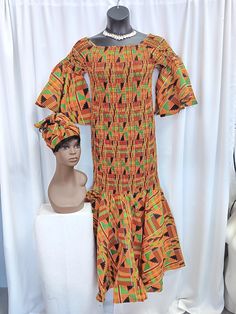 "Beautiful African Kente fabric elastic to knees fishtail dress with matching headwrap. elastic top sleeves flare to below elbow. Fits in all the right places.  Measurements: 30\" - 44\" FREE SIZE (FITS MOST MED TO XL)" Fitted Multicolor Midi Dress With Gathered Sleeves, Bohemian Fitted Dress With Elastic Sleeves, Fitted Bohemian Maxi Dress With Gathered Sleeves, Bohemian Fitted Maxi Dress With Gathered Sleeves, Kente Fabric, Elastic Dress, Elastic Top, Fishtail Dress, African Mud Cloth