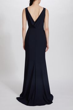 the back of a woman wearing a black evening gown