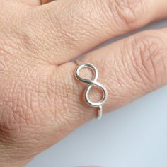 infinity Modern Twist Infinity Stackable Rings As Gift, Sterling Silver Infinity Ring With A Modern Twist, Modern Sterling Silver Infinity Ring, Minimalist Infinity Rings With Adjustable Fit, Minimalist Infinity Rings Adjustable, Minimalist Infinity Stackable Rings For Everyday, Minimalist Infinity Stackable Rings, Modern Infinity Stackable Rings For Anniversary, Minimalist Adjustable Infinity Rings