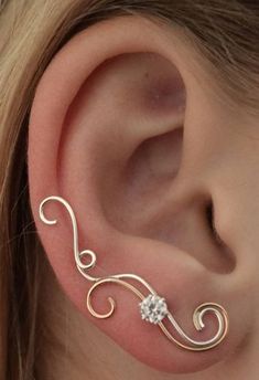 a woman's ear is adorned with an intricate design