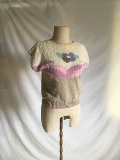 "vintage 1980s women's pullover sweater Worthington Petite made in Taiwan 52% ramie, 48% cotton knit white/beige w/ pastel floral pattern good vintage condition, light wear very faint faded tiny stain in tan lower front-see photos elastic at hem is tied and loops show a bit, tuck in easily label size S, loose fit, see below measures, lying flat, shoulder-21\" chest-18\" hem-13\" to 16\" length-19 1/2\"" Vintage Knitted Beige Tops, Vintage Beige Knitted Tops, Beige Knit Retro Top, Retro Beige Knit Tops, Vintage Beige Crew Neck Top, Vintage Cream Knit Tops, Spring Crew Neck Sweater Vest, Retro Cream Knit Tops, Cream Knit Retro Top