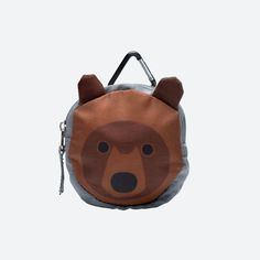 a small bag with a brown bear on it's face and ears hanging from the front