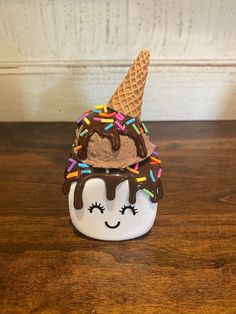 an ice cream sundae with chocolate and sprinkles on it's face