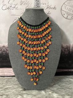 Beautiful necklace and earrings with round flowers, made with beads by Mexican artisans, it is a colorful piece that highlights any outfit. Unique Multicolor Flower-shaped Beaded Earrings, Orange Beaded Flower-shaped Jewelry, Multicolor Flower Shaped Jewelry With Colorful Beads, Traditional Adjustable Flower Beaded Necklace, Handmade Orange Flower-shaped Jewelry, Bohemian Flower-shaped Beaded Earrings, Traditional Multicolor Flower Beaded Necklace, Traditional Multicolor Flower Necklace, Flower-shaped Beaded Necklace For Festival