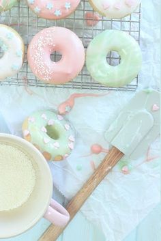 doughnuts and other pastries on a cooling rack, including one with sprinkles