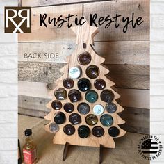 a wooden christmas tree made out of bottles and magnets with the words rustic restyle on it