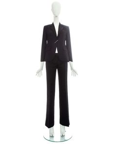 For Sale on 1stdibs - Gucci by Tom Ford black croc embossed flared pant suit with silver diamanté clasp fastening. Spring-Summer 2000 Chic Gucci Notch Lapel Blazer, Chic Gucci Blazer With Notch Lapel, Elegant Black Gucci Blazer, Gucci Notch Lapel Suit For Formal Occasions, Classic Gucci Business Suits, Gucci Notch Lapel Suits For Work, Classic Gucci Suits For Business, Classic Fitted Gucci Suit, Classic Tailored Gucci Suits