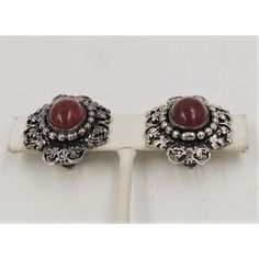 This is part of Chairish’s Costume Jewelry assortment.  Circa 1960s or late 1950s sterling silver faux-carnelian cabochon floral motif butterfly clip back earrings. Marked "Napier." Measure: 1 1/8 inches long by 7/8 inches.  Condition: Very good; some tarnishing normal for their age.   Please reference the measurements noted in the description above for the best approximate dimensions. Please reach out to the seller under "Ask the Seller" for specific questions regarding the measurements. Formal Clip-on Earrings With Oval Cabochon, Vintage Round Gemstone Cabochons, Vintage Sterling Silver Clip-on Earrings, Elegant Oval Cabochon Clip-on Jewelry, Vintage Oval Cabochons For Formal Occasions, Classic Cabochon Clip-on Earrings, Vintage Oval Cabochon For Jewelry Making, Vintage Gemstone Cabochons For Gifts, Vintage Cabochon Clip-on Earrings For Formal Occasions