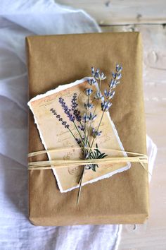 a wrapped gift with lavender flowers tied to it