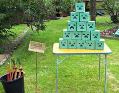 a bunch of blocks sitting on top of a table next to a black trash can