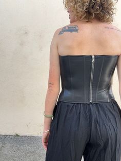 Miaou Black Vegan Leather Bustier. A super sexy black vegan leather sleeveless bustier with a spiky neckline that makes it even more badass. Boning adds structure, has some stretch for a snug fit. Zipper closure up the back. Shell is a vegan leather is made from a poly-rayon blend, lining is a recycled poly-spandex blend. Marked size S. In excellent, like-new condition. Approximate Measurements: Underarm to underarm: 16.5" Length: 13.5" Waist: 14.5" across Fitted Gothic Corset With Zipper Closure, Edgy Sleeveless Tube Top For Club, Fitted Sleeveless Corset With Zipper Closure, Black Edgy Overbust Corset, Gothic Black Corset With Zipper Closure, Edgy Black Overbust Corset, Edgy Underbust Corset With Corset Back, Gothic Strapless Corset For Club, Edgy Fitted Crop Top For Night Out