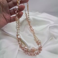 Two Pretty baby pink pearl necklaces. Both are sold together for the price of $50.00  one necklace has large pink baroque pearls and white rice pearls mixed Intermittently.  The other has small dainty pink baroque baby pearls .A lovely mix of quality natural freshwater pearls. A beautiful gift for your wife girlfriend sweetheart or just a new addition to your jewelry box.   These necklaces will be a staple for your feminine outfits.  Ready to dispatch to you in one business day..my handmade items are one of a kind....special and distinctive.   Thanks for visiting my shop GemsbyZoey... Elegant Pink Pearl Drop Necklace, Pink Pearl Jewelry With Pearl Chain, Pink Pearl Beaded Necklace With Pearl Charm, Handmade Pink Pearl Beaded Necklaces, Handmade Long Pearl Necklace, Feminine Pink Pearl Necklace For Wedding, Elegant Pink Pearl Beaded Necklace, Feminine Pink Pearl Necklace, Pink Pearl Charm Necklace For Wedding