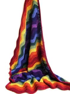 a multicolored crocheted blanket on a white background