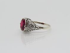 Vintage Sterling Silver Oval cut Ruby Filigree Ring...Marked 925...Total of weights 2.8grams.. Size 9...Measure of Face 10.9mm...It's in very good condition Engraved Oval Filigree Ring In White Gold, Ornate Oval White Gold Filigree Ring, White Gold Oval Filigree Ring Engraved, Oval White Gold Filigree Ring Engraved, Engraved Oval Filigree Ring For Promise, Engraved Filigree Oval Promise Ring, Engraved Oval Filigree Promise Ring, Ornate Oval Filigree Ring With Diamond Cut, Ornate Oval Engraved Hallmarked Ring