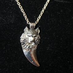 This Necklace Is Made From A Pewter Blank And Hand Enameled By Me. The 3-D Wolf Head Portrait Has The Natural Silver Gray Coloring Of A Timber Wolf And Is Placed At The Top Of A Silver Toned Claw/Tooth. It Is Subtle And Has The Quiet Power Of The Wolf. The Pendant Is 2" Long By 5/8" Wide. It Hangs From A Silver Toned, Nickel Free Cable Chain That Is 18" Long And Extendable To 20" With A Lobster Claw Clasp. This Necklace Would Look Great With Southwestern Attire Or Other Clothing Where You Wish T Nickel-free White Gold Necklace, Nickel-free Silver Charm Necklace, Symbolic Hallmarked Metal Jewelry, Symbolic White Gold Metal Necklace, Hallmarked Silver Stainless Steel Necklaces, Nickel-free Silver Stainless Steel Necklace, Nickel-free Silver Stainless Steel Jewelry, Silver Stainless Steel Jewelry For Jewelry Making, Oxidized Silver Stainless Steel Necklace