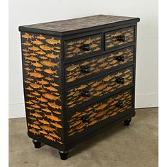 a black and gold painted chest of drawers