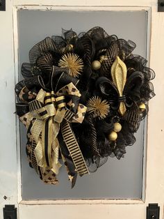 a black and gold wreath hanging on a door