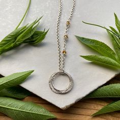 This elegant necklace offers up a unique combination of playfulness & timeless style. Three organically shaped & uniquely textured sterling silver circles layer gracefully on a lovely sterling silver double cable chain. Each ring is handcrafted individually to represent your journey through the decades. Circles are hammered flat & strong, and given a rustic sparkly texture. Three gemstones are intricately wrapped on the chain, creating a lovely birthstone accent. Choose from 15 gemstones! (Gems Anniversary Sterling Silver Hammered Necklace, Sterling Silver Hammered Necklace For Anniversary, Sterling Silver Hammered Necklaces For Anniversary, Hammered Sterling Silver Necklaces For Anniversary, Adjustable Sterling Silver Necklace With Round Pendant, Adjustable Sterling Silver Round Pendant Necklace, Circular Jewelry With Adjustable Chain For Gift, Adjustable Full Circle Jewelry Gift, Sterling Silver Birthstone Necklace With Adjustable Chain For Anniversary