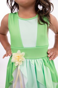 When you twirl in this enchanted green dress, it's as if you're caught in a joyful breeze, and the skirt flutters like the leaves in a magical forest. Designed for twirling - cut from a full circle of fabric which allows it to billow out as your little one spins and dances Gracefully tiered skirt, with three layers of flowing fabric that cascade elegantly Sunshine-hued flower embellishment at the waist for a finishing touch Made from breathable, stretchy, mid-grade soft knit fabrics Accessories Spring Fairytale Fairy Dress For Dress-up, Fairy Style Dress-up Dresses For Summer, Fairy Style Dress For Summer Dress-up, Green Fairy Dress For Dress-up, Green A-line Dress For Garden Party, Summer Sleeveless Fairytale Fairy Dress, Sleeveless Fairytale Fairy Dress For Summer, Fitted Fairytale Princess Dress For Spring, Fairytale Dresses For Summer Garden Party