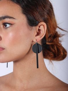 Expertly crafted from premium cowhide leather and 925 silver plated mini hoops, these Dot Line Mini Hoop Earrings by Aumorfia add a touch of sophistication to any outfit. The unique design features a dot and a line hanging from a sterling hoop. Handmade in Greece by their local craftsmen. Dimensions: 1" x 3"Dimensions(hoop): .5" Handmade Leather Hoop Earrings, Minimalist Leather Earrings For Everyday, Black Leather Earrings As A Gift, Black Leather Drop Earrings, Minimalist Black Leather Jewelry, Minimalist Black Jewelry With Leather Strap, Modern Adjustable Black Earrings, Mini Hoop Earrings, Hoops Earrings