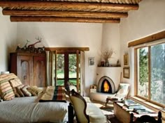 a living room filled with furniture and a fire place in the middle of a room