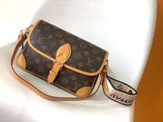 LV Diane Monogram Canvas Coated Bag M45985 is full of retro 90s style, which equipped with a leather hand & shoulder strap. As well as with a wide jacquard shoulder strap (can be worn across the body), both are the detachable not adjustable. The capacity is enough for daily use to hold the largest mobile phone without any pressure. The belt-style buckle is a decoration, but it is actually a magnet to open and close. Monogram coated canvas. Black color textile lining. Cowhide leather tr... Louis Vuitton Diane, Armani Wallet, Armani Belt, Fendi Belt, Ferragamo Belt, Saint Laurent Wallet, Dior Wallet, Prada Wallet, Chanel Belt