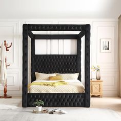 a black bed frame in a white room