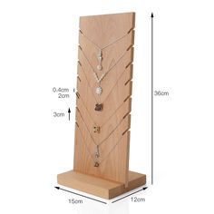 a wooden display case with multiple necklaces on it and measurements for each item in the image