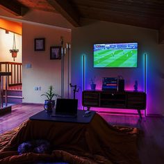 a living room filled with furniture and a flat screen tv mounted to the side of a wall