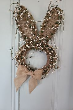 a bunny shaped wreath hanging on the front door