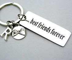 the best friends forever keychain is shown on a gray surface with an image of a person holding a dog