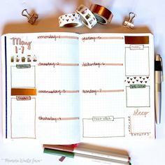 an open planner book with washi tape and other items on it, including pencils