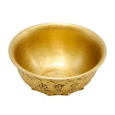 a gold bowl with intricate designs on the rim