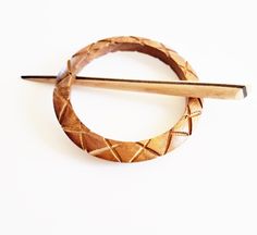 Beautiful handmade wooden scarf pin. Designed for handwoven and knitted items such as shawls, scarves, jackets etc. Beautiful accessory, my pins are comfortable to wear, lightweight, so they don't weigh down your knits and woven shawls,and scarves The dimensions of the pin are: the outside diameter is 9 cm the inner diameter is 6.5. cm and the pin is about 14 cm long. Product code 004