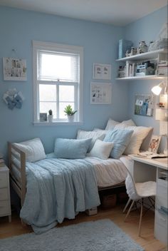 a bedroom with a bed, desk and shelves in the corner next to a window