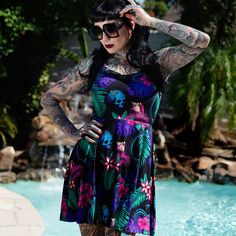 Summer goes dark with The Black Mast Tropigoth Skater Dress.This colorful and creepy tropical pattern is a great way to keep cool over summer. This all-over print features mermaid skeletons, skulls with barnacles, and eel skeletons lurking among the palm fronds, monstera leaves, hibiscus and plumeria flowers. Wear it to the beach, the club, the tiki bar, or any of your other favorite haunts!Please check the size chart below, and go a size down for a more snug fit.• 82% polyester, 18% spandex• Sm Tropical Goth Aesthetic, Tiki Outfit Women, Tiki Outfit, Tropical Goth, Mermaid Skeleton, Plumeria Flowers, Tiki Party, Monstera Leaves, Palm Fronds