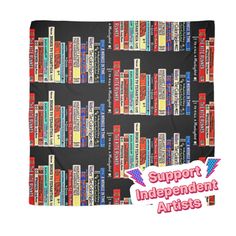 a black blanket with red, white and blue bookshelves printed on it that says support independent artists