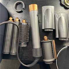 several different types of microphones and accessories on a black table with gold trimming