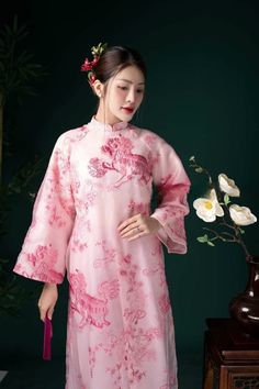 "🌿 This set includes traditional Ao Dai, red pants. Style: Traditional Material: Very well made with high-quality double layers Collar: traditional collar Please provide bust-waist-and hip measurements when placing your order to ensure the best fit for you. 🌿 NOTE: * Recommend gentle washing * Please contact us for any inquiries about size. We don't have an exchange policy for the wrong size * It is safe for a washer and dryer in a \"delicate\" setting. * Actual Ao Dai colors may differ up to 10% due to lightning and viewing devices. * These ao dai pants are made based on Vietnamese size; they will run smaller than American size. *3D printed ao dai: you may see some white broken fabric around the seam (collar). *There might be some chalk/ pen writings on the fabric because it is brand ne Luxury Embroidered Ao Dai For Party, Elegant Ceremonial Dress With Floral Embroidery, Transitional Wedding Dress With Intricate Embroidery, Traditional Embroidered Dress For Ceremony, Long Sleeve Dresses With Intricate Embroidery For Ceremonial Occasions, Traditional Ao Dai With Floral Embroidery For Wedding, Traditional Ao Dai With Intricate Embroidery For Festive Occasions, Transitional Season Embroidered Wedding Gown, Long Sleeve Wedding Dresses With Floral Embroidery