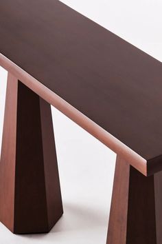 a wooden bench sitting on top of a white floor