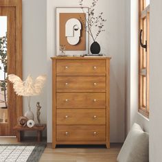 a wooden dresser sitting next to a window in a living room