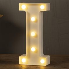 a white light up letter shaped like the letter i with lights on it's sides