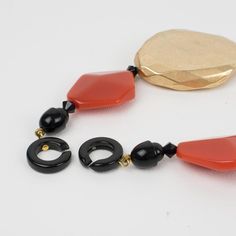 This is part of Chairish’s Costume Jewelry assortment.  This refined Angela Caputi, made in Italy, resin choker necklace is built on the gilded metallic coating resin with burnt orange contrast. Each organic pebble bead is carved, dimensional, and geometric. Her matching of colors is always extremely classy, perfect for casual and fancy occasions. As you know, Caputi jewelry is not signed. This is a pre-owned necklace, and the plastic tag was removed.  This piece has the brand's signature two-ri Elegant Orange Glass Jewelry, Handmade Resin Jewelry For Formal Occasions, Elegant Orange Resin Jewelry, Elegant Amber Resin Jewelry, Adjustable Elegant Resin Necklace, Resin Choker, Gold And Orange, Lucite Jewelry, Modern Branding