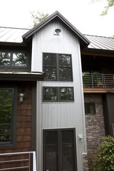 a house that is made out of metal and has windows on the side of it