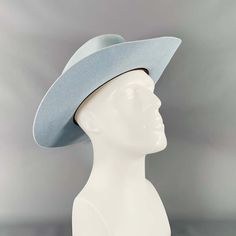 Teressa Foglia Hat In A Light Blue Felt Featuring A Wide Brimmed Fedora Style With Subtle White Stitching Trim Details.Very Good Pre-Owned Condition With Box. Minor Signs Of Wear. Measurements: Opening: 22.5 Inches Brim: 3.5 Inches Height: 4.75 Inches Sui Generis Reference: 133584 Category: Hats More Details Brand: Teressa Foglia Size: 7 3/8 Color: Blue Fabric: Felt. Condition: With Box Age Group: Adult Sui Generis Designer Consignment Is An Award Winning Fashion Resale Store For Women & Men. Lo Classic Blue Brimmed Felt Hat, Blue Classic Felt Hat With Short Brim, Classic Blue Felt Hat With Short Brim, Classic Blue Wide Brim Felt Hat, Classic Fitted Blue Hat, Blue Flat Brim Felt Hat For Kentucky Derby, Blue Fitted Fedora With Flat Brim, Blue Western Fedora With Wide Brim, Blue Western Wide Brim Fedora