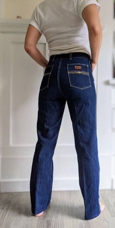 "NOS \" Tyme\" vintage jeans, union made in Canada, labeled size 30, \"Keith\" style. Look unworn, dark blue heavy denim with yellow stitching. High waist, straight leg, ykk zipper. Measurements laying flat in inches: Waist 14.5 Hips 17 Inseam 29 Waist to hem 40 Waist to crotch 12 8\" leg cuff" Retro Straight Leg Bottoms With Contrast Stitching, Retro Dark Wash Rigid Denim Flare Jeans, Retro Flare Jeans In Dark Wash Rigid Denim, Vintage Straight Leg Jeans With Contrast Stitching, Retro Dark Wash Rigid Denim Jeans, Retro Medium Wash Standard Cut Jeans, Retro Jeans With Medium Wash And Standard Cut, Retro Medium Wash Jeans, Retro Dark Wash Jeans With Belt Loops